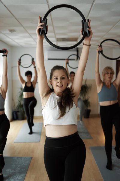 Group of women practicing Pilates exercises in class