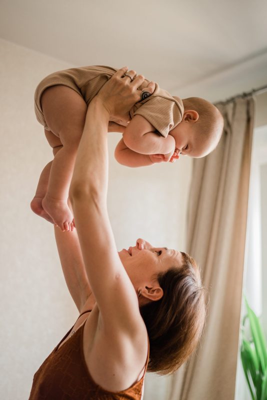 mom-is-holding-her-little-baby-infant-up-on-her-ha-2024-10-18-03-35-22-utc