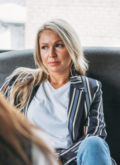 Upset young woman in the office of psychotherapist or doctor, women communicate to each other